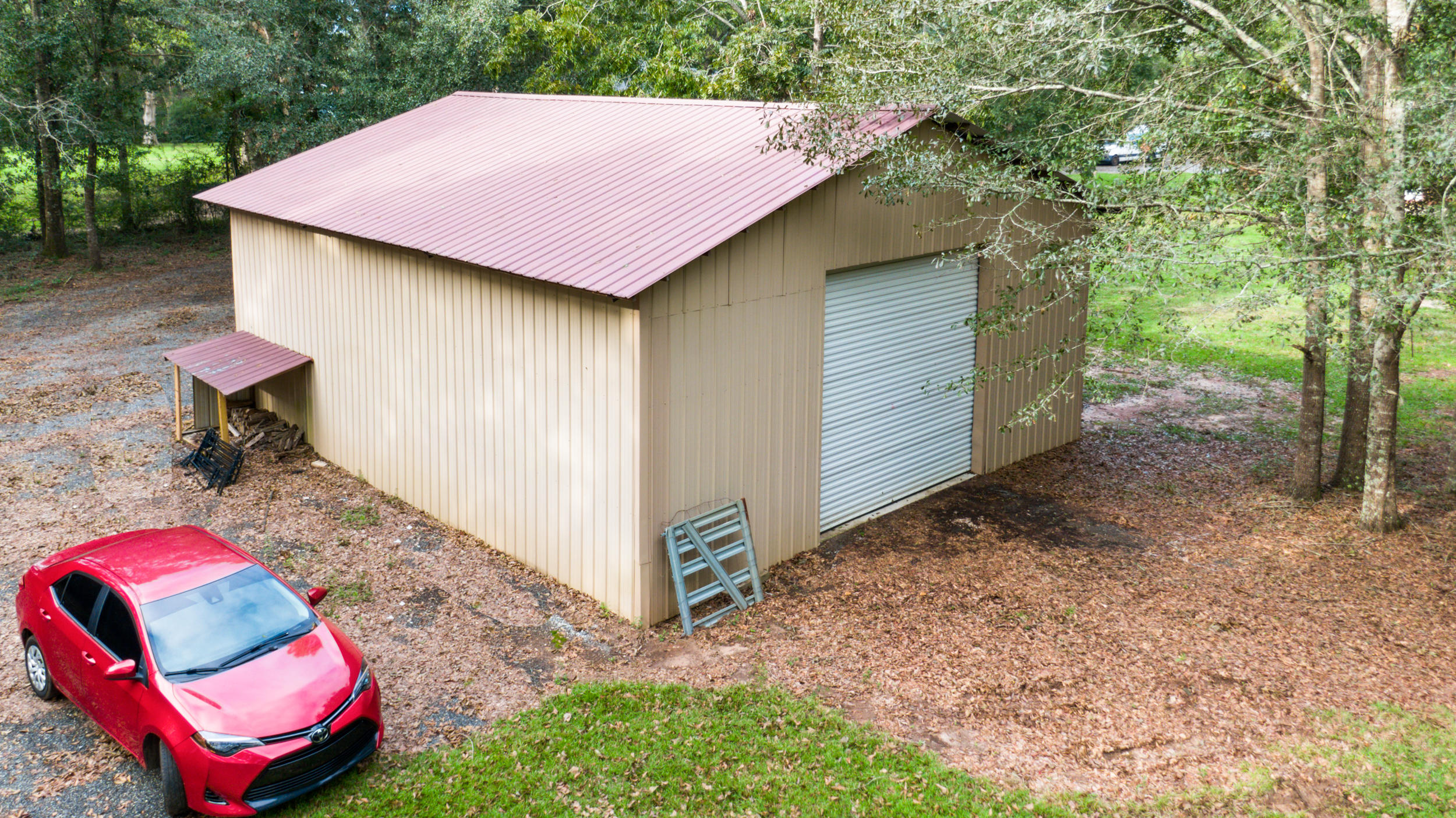 5975 Jack Stokes Road Baker, FL 32531 - Photo 40 of 44 a backyard of a house with seating space