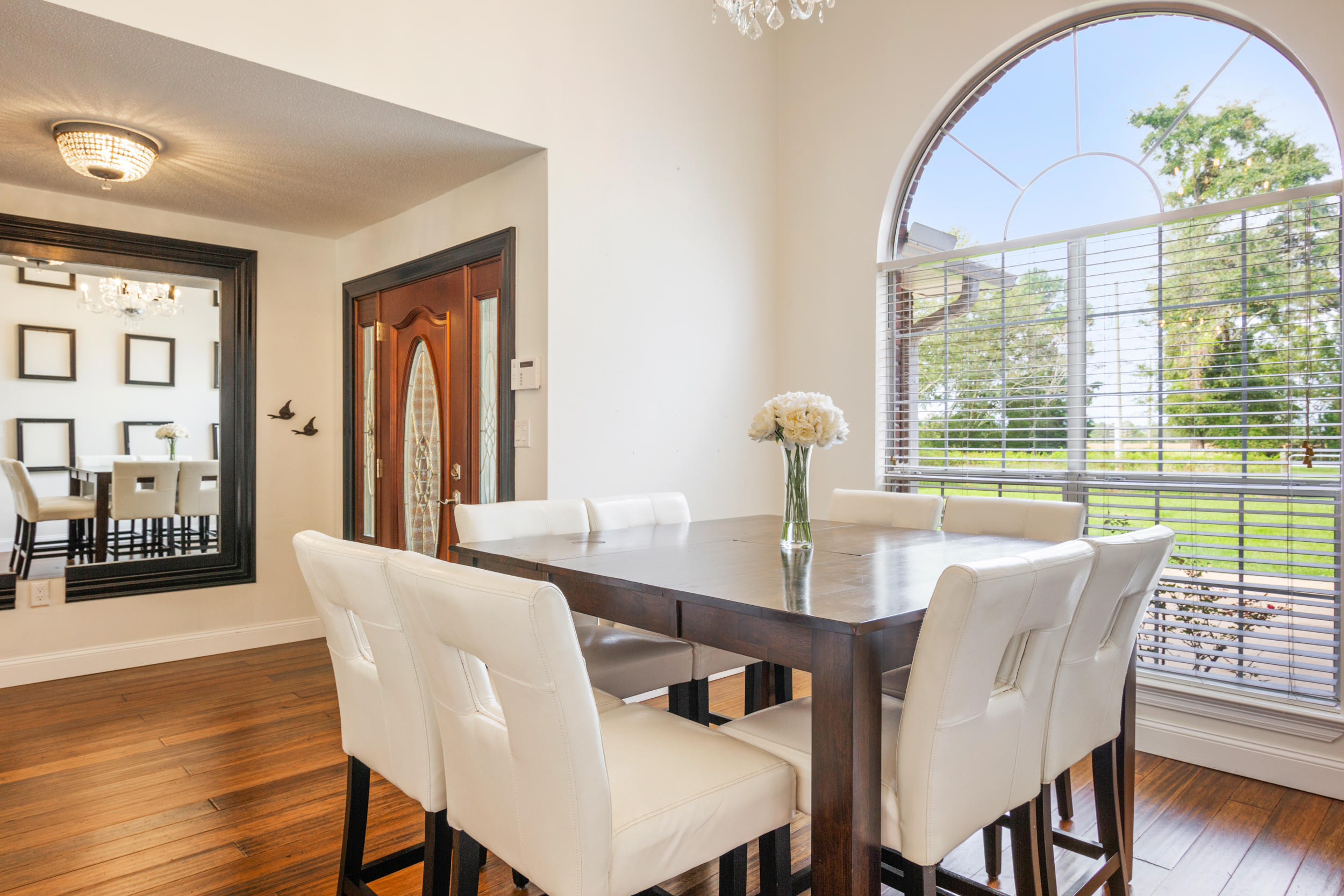 5975 Jack Stokes Road Baker, FL 32531 - Photo 8 of 44 a view of a dining room with furniture window and wooden floor