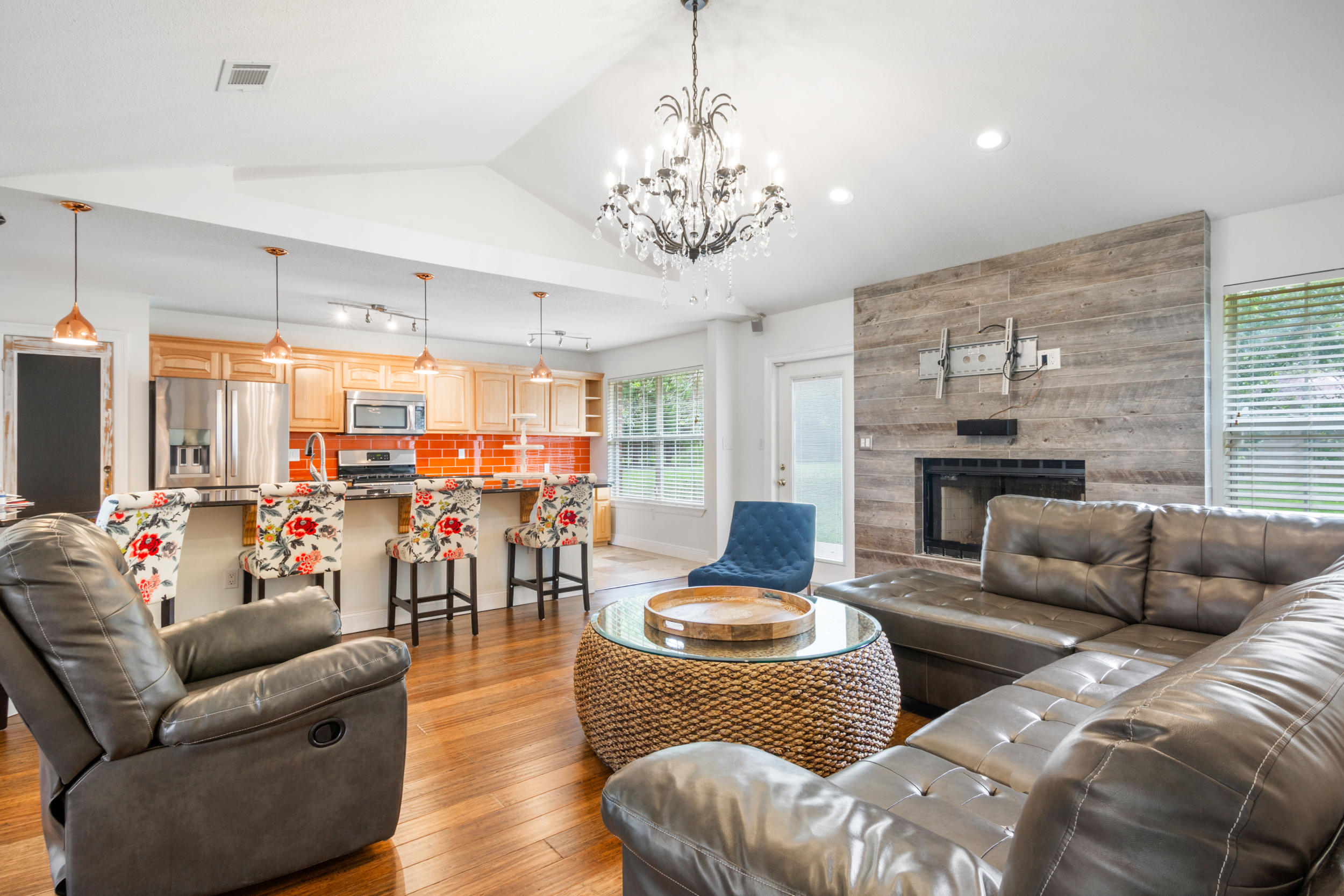 5975 Jack Stokes Road Baker, FL 32531 - Photo 10 of 44 a living room with furniture kitchen view and a chandelier