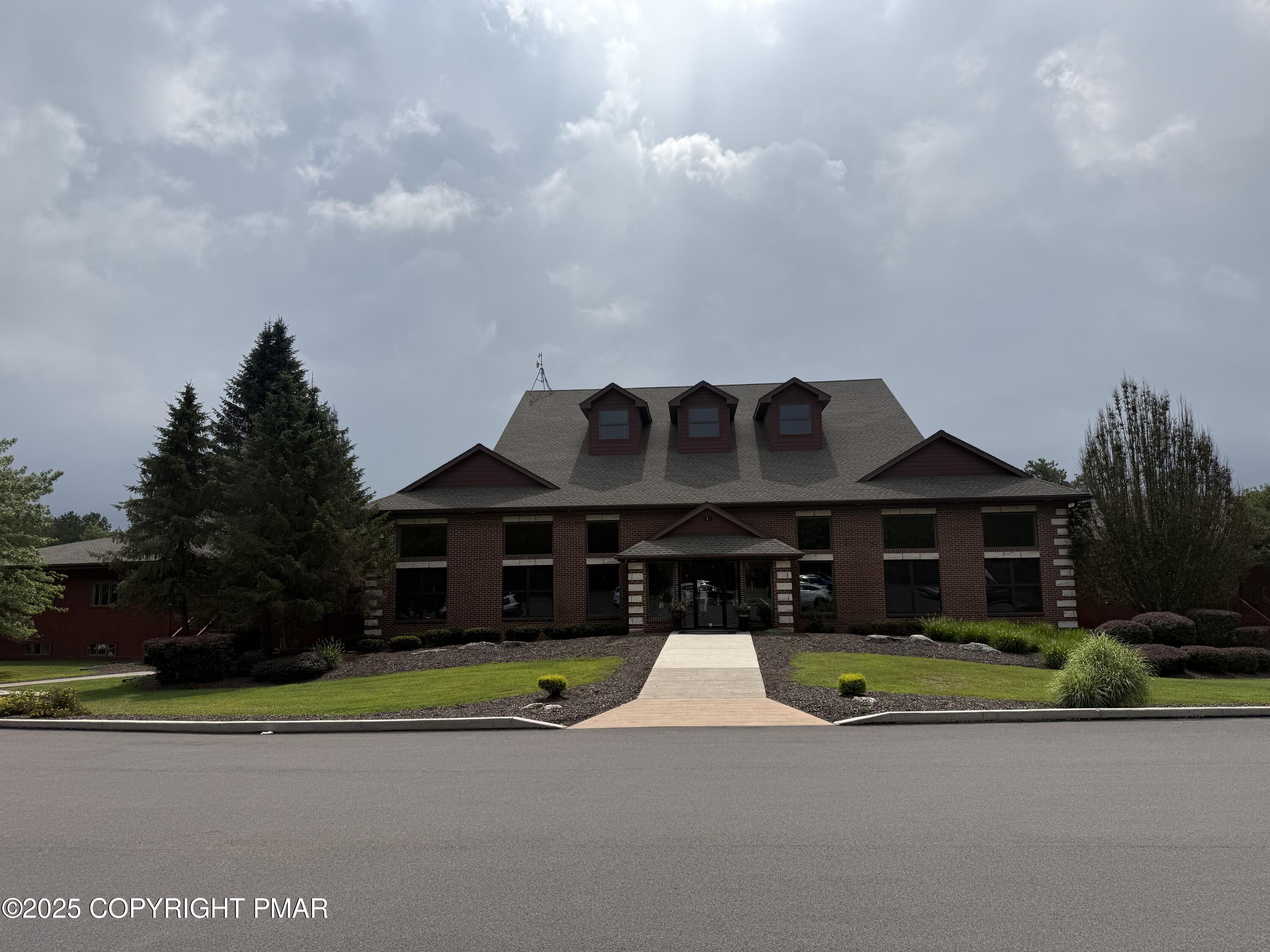 a view of a house with a big yard and large trees