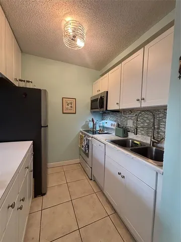 a kitchen with a cabinets and a stove top oven