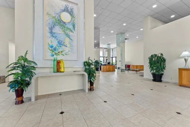 a view of living room filled with furniture and potted plant