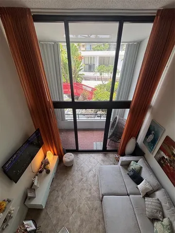 a view of an outdoor space with the couches and wooden floor