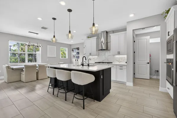 a large kitchen with a table and chairs