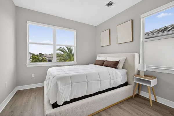 a large bed sitting in a bedroom next to a window