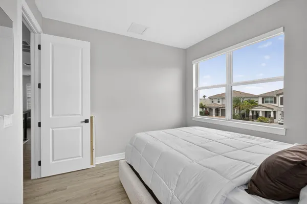 a bedroom with a bed and a window