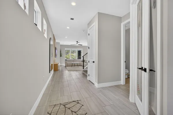 a view of a hallway view with wooden floor and staircase