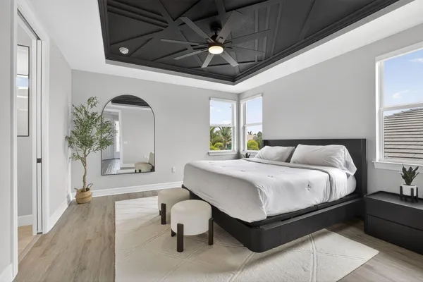 a spacious bedroom with a bed and a chandelier