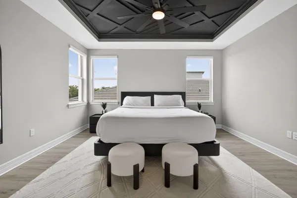 a bedroom with a bed and wooden floor