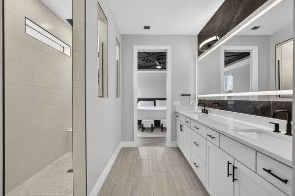 a spacious bathroom with a double vanity sink and a mirror