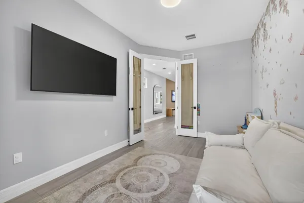 a living room with furniture and a flat screen tv