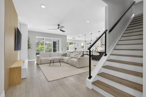 a living room with furniture and wooden floor