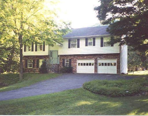 327 Limestone Road Ridgefield, CT 06877 - Photo 1 of 1 a front view of a house with a yard and garage