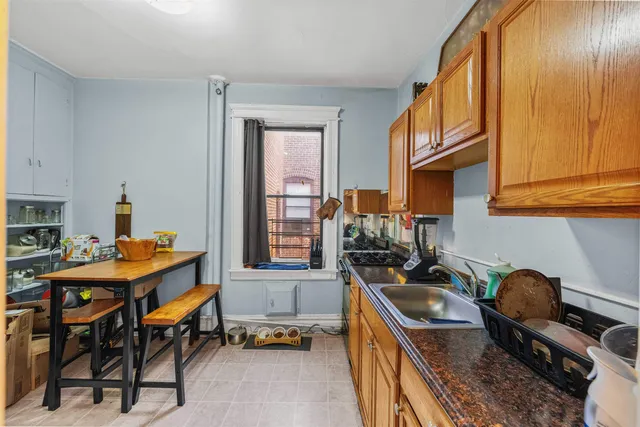 a kitchen that has a table and chairs in it