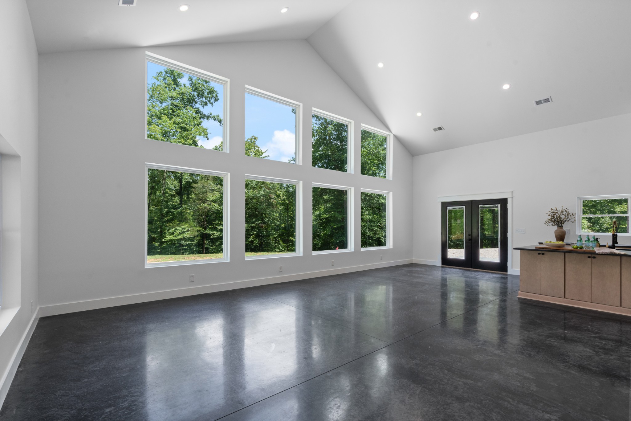 7922 East Plunders Creek Road Dickson, TN 37055 - Photo 7 of 86 a view of an empty room with wooden floor and a window