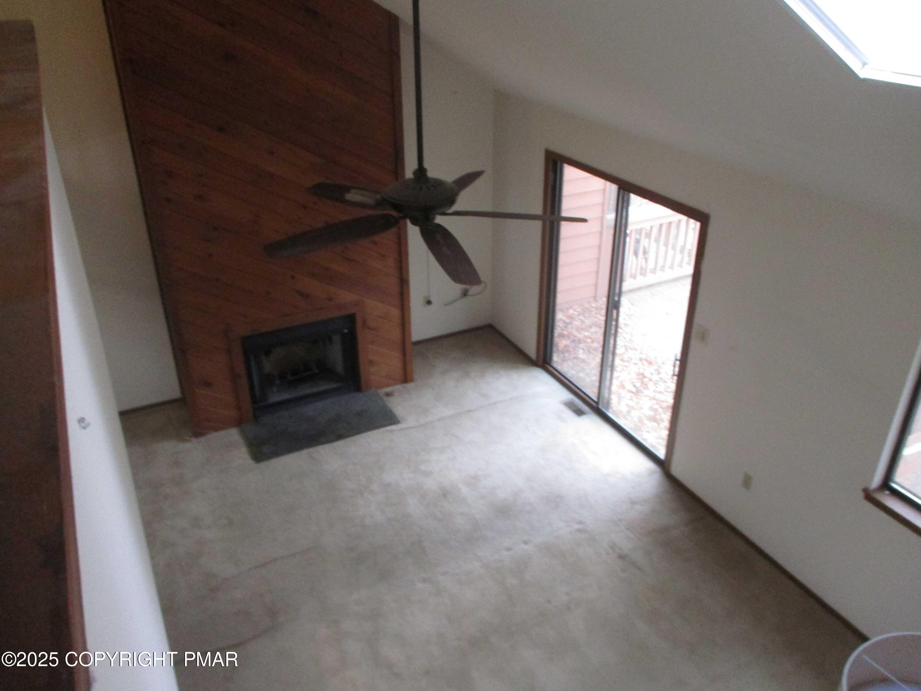 159 Stream Court Bushkill, PA 18324 - Photo 12 of 26 a view of empty room with fireplace and window
