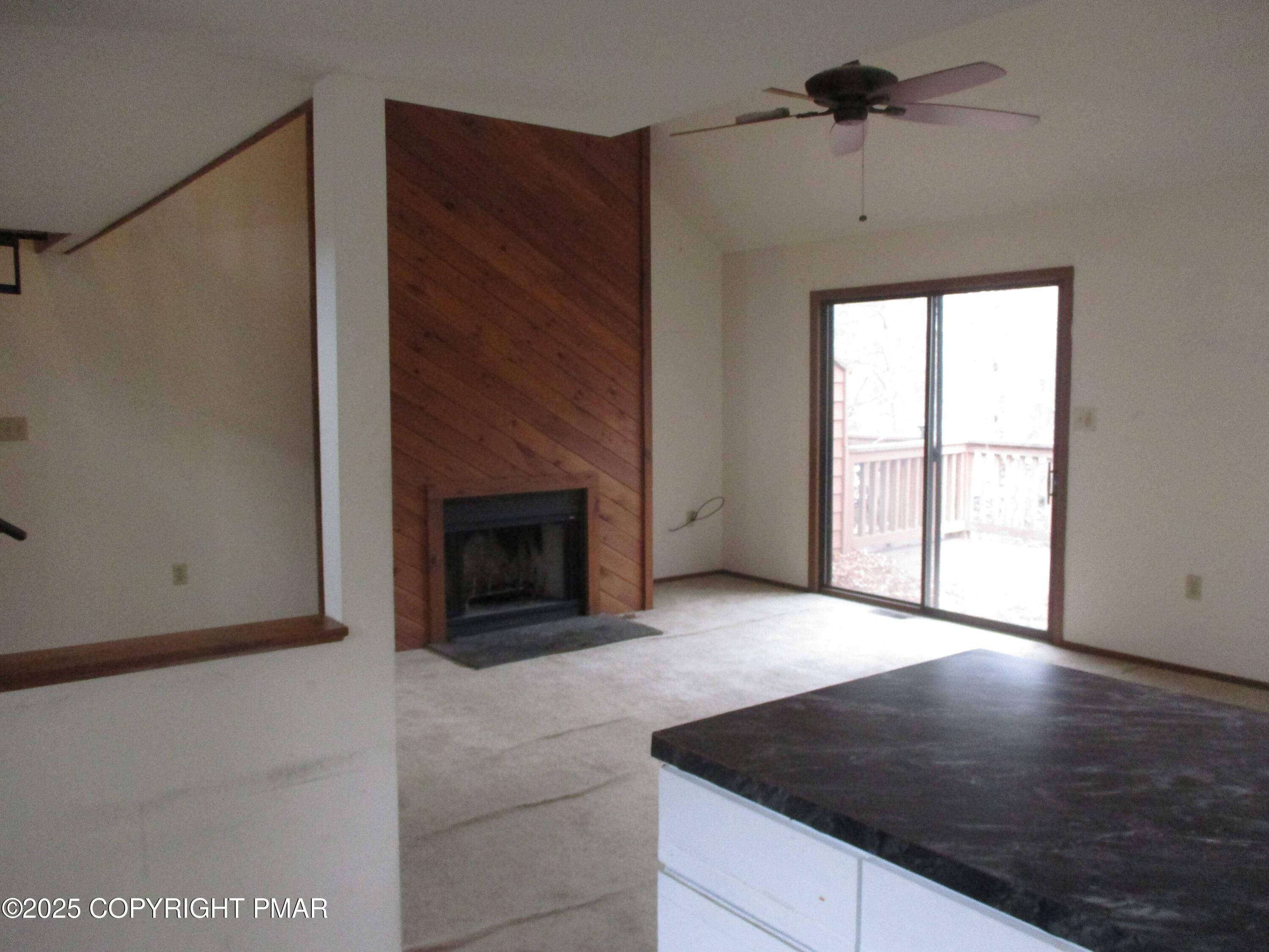 159 Stream Court Bushkill, PA 18324 - Photo 9 of 26 a view of an empty room with a fireplace and a window