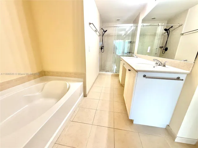 a bathroom with a tub sink and mirror