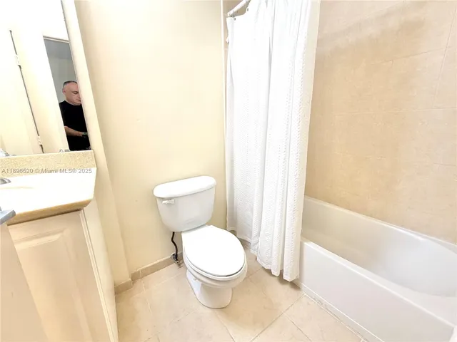 a white toilet sitting next to a bath tub