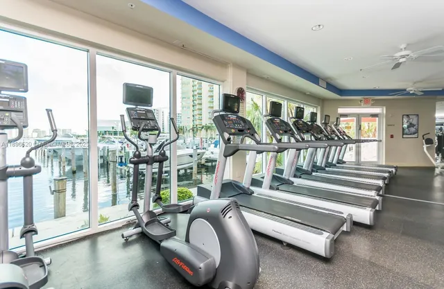 a bedroom with furniture and a large window