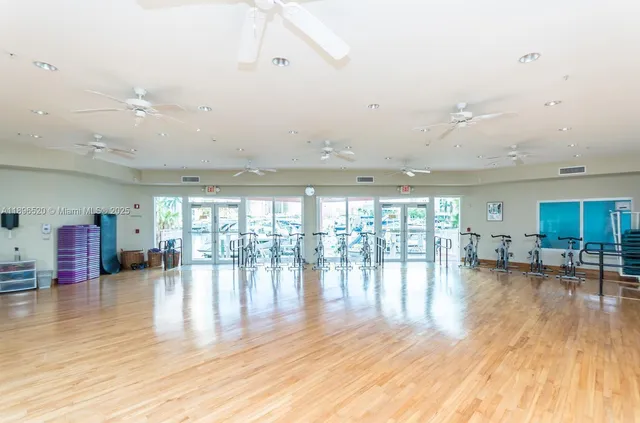 an empty room with wooden floor and outdoor view