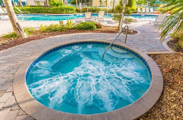 a view of a swimming pool with a porch and sitting area