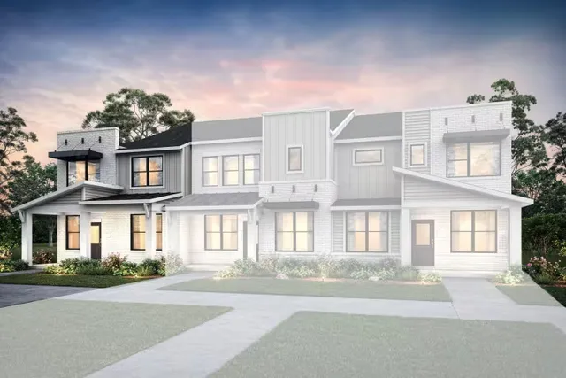 front view of a brick house with a yard