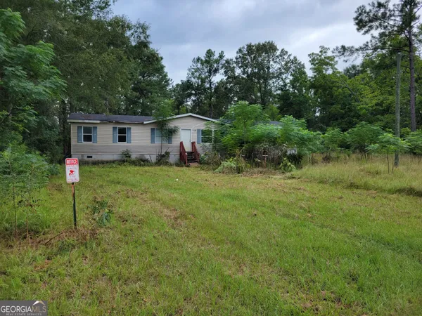 a view of a house with yard and a tree