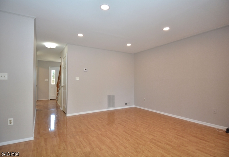 129 Hampton Court Somerset, NJ 08873 - Photo 12 of 25 an empty room with wooden floor and windows