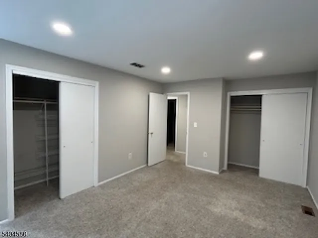 an empty room with closet and bathroom
