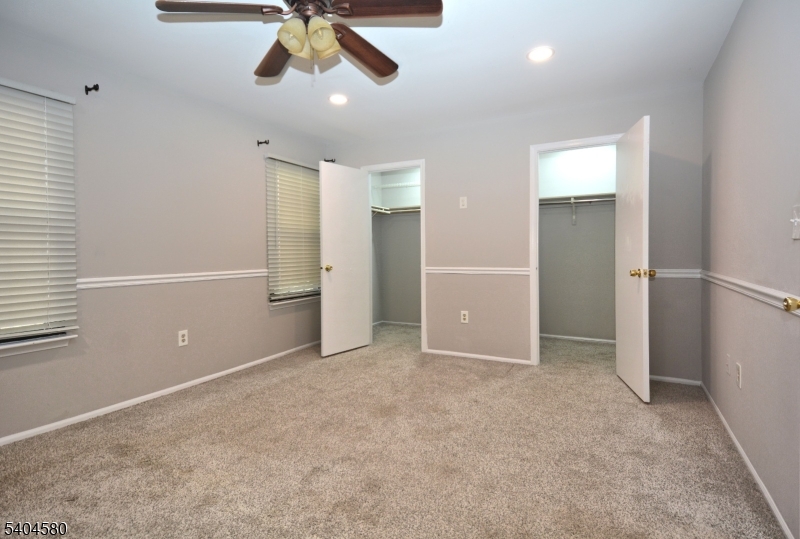 129 Hampton Court Somerset, NJ 08873 - Photo 15 of 25 an empty room with closet and a chandelier fan