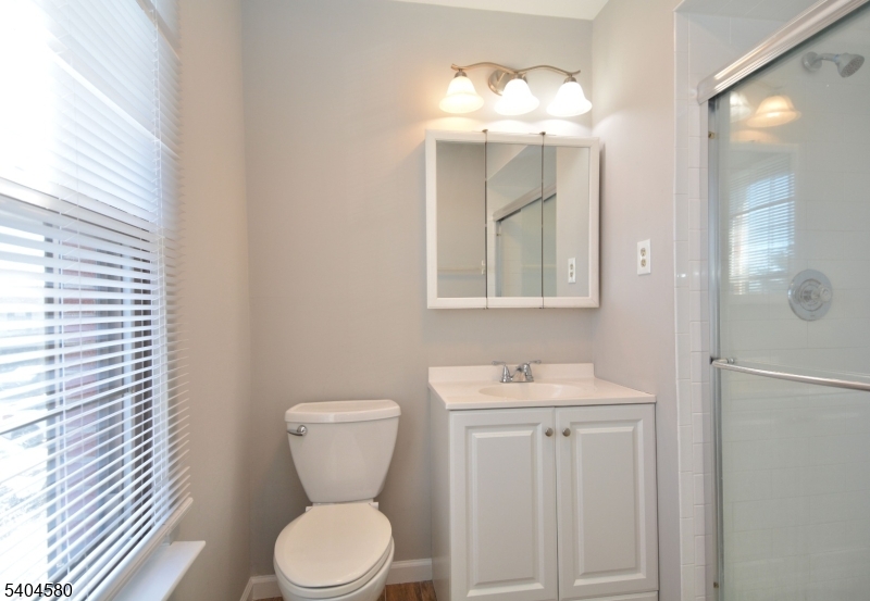 129 Hampton Court Somerset, NJ 08873 - Photo 21 of 25 a bathroom with a toilet sink and mirror