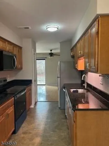 a kitchen that has a sink and a stove