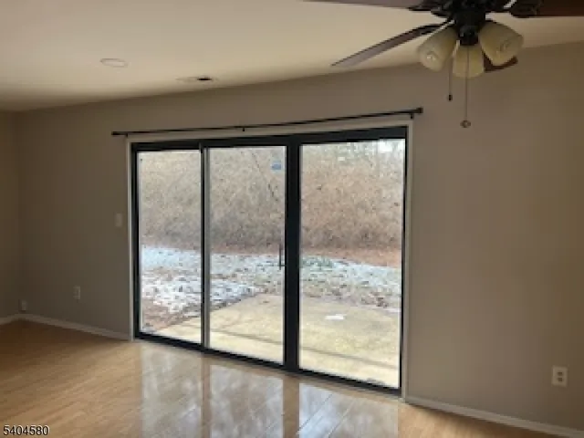 a view of room with window and wooden floor