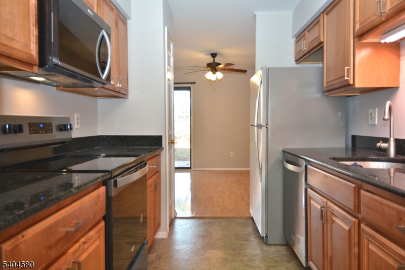 129 Hampton Court Somerset, NJ 08873 - Photo 6 of 25 a kitchen with stainless steel appliances granite countertop a stove and a refrigerator