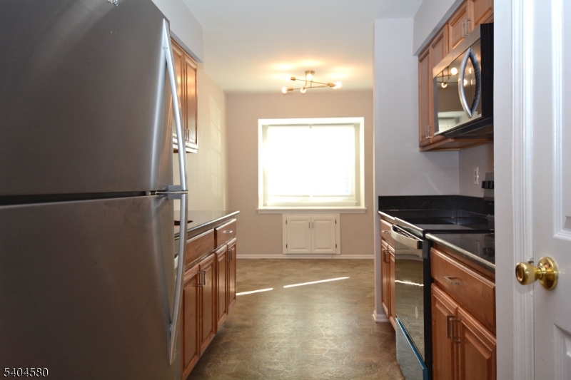 129 Hampton Court Somerset, NJ 08873 - Photo 8 of 25 a kitchen with a refrigerator and a window