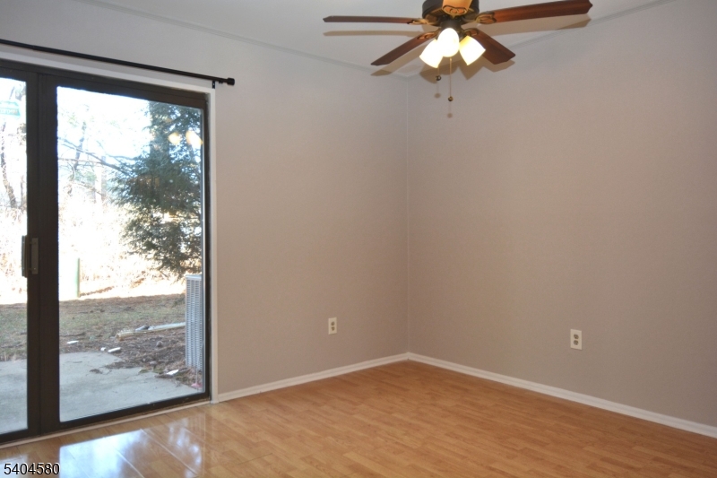 129 Hampton Court Somerset, NJ 08873 - Photo 9 of 25 a view of an empty room with wooden floor and a window