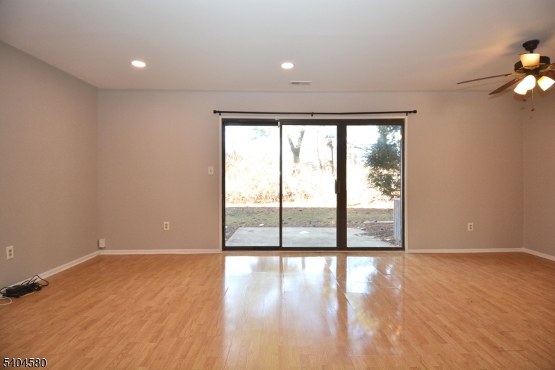 129 Hampton Court Somerset, NJ 08873 - Photo 10 of 25 a view of an empty room with wooden floor and a window