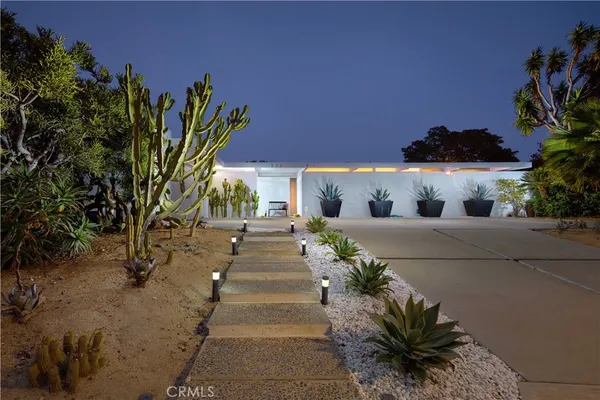 a view of a house with a yard and garden