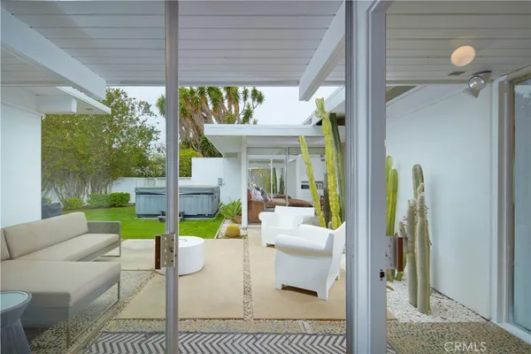 a view of a house with backyard sitting area and garden