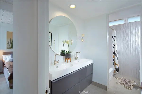 a spacious bedroom with a bed and a couch