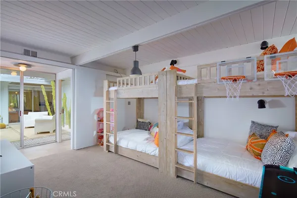 a living room with patio furniture and a garden