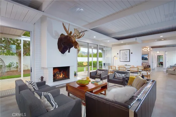 a living room with furniture fireplace and a large window