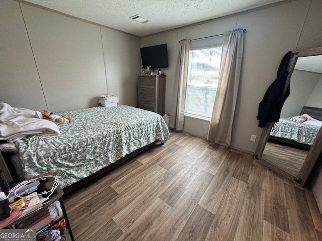 2470 Kitchen Road Dexter, GA 31019 - Photo 12 of 56 a bedroom with a bed and wooden floor