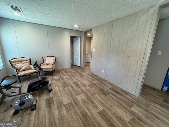 a view of a room with lounge chair and wooden floor