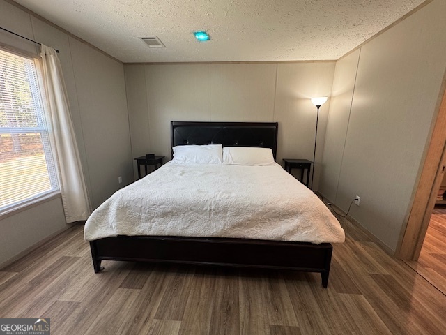2470 Kitchen Road Dexter, GA 31019 - Photo 16 of 30 a large bed sitting in a bedroom next to a window