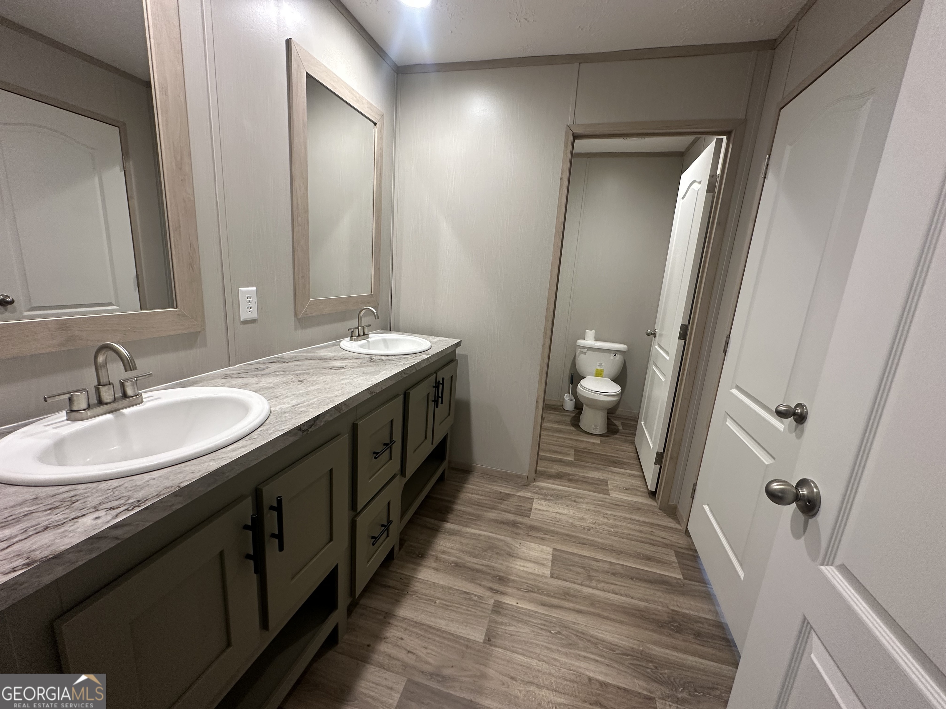2470 Kitchen Road Dexter, GA 31019 - Photo 28 of 56 a spacious bathroom with a double vanity sink and a mirror