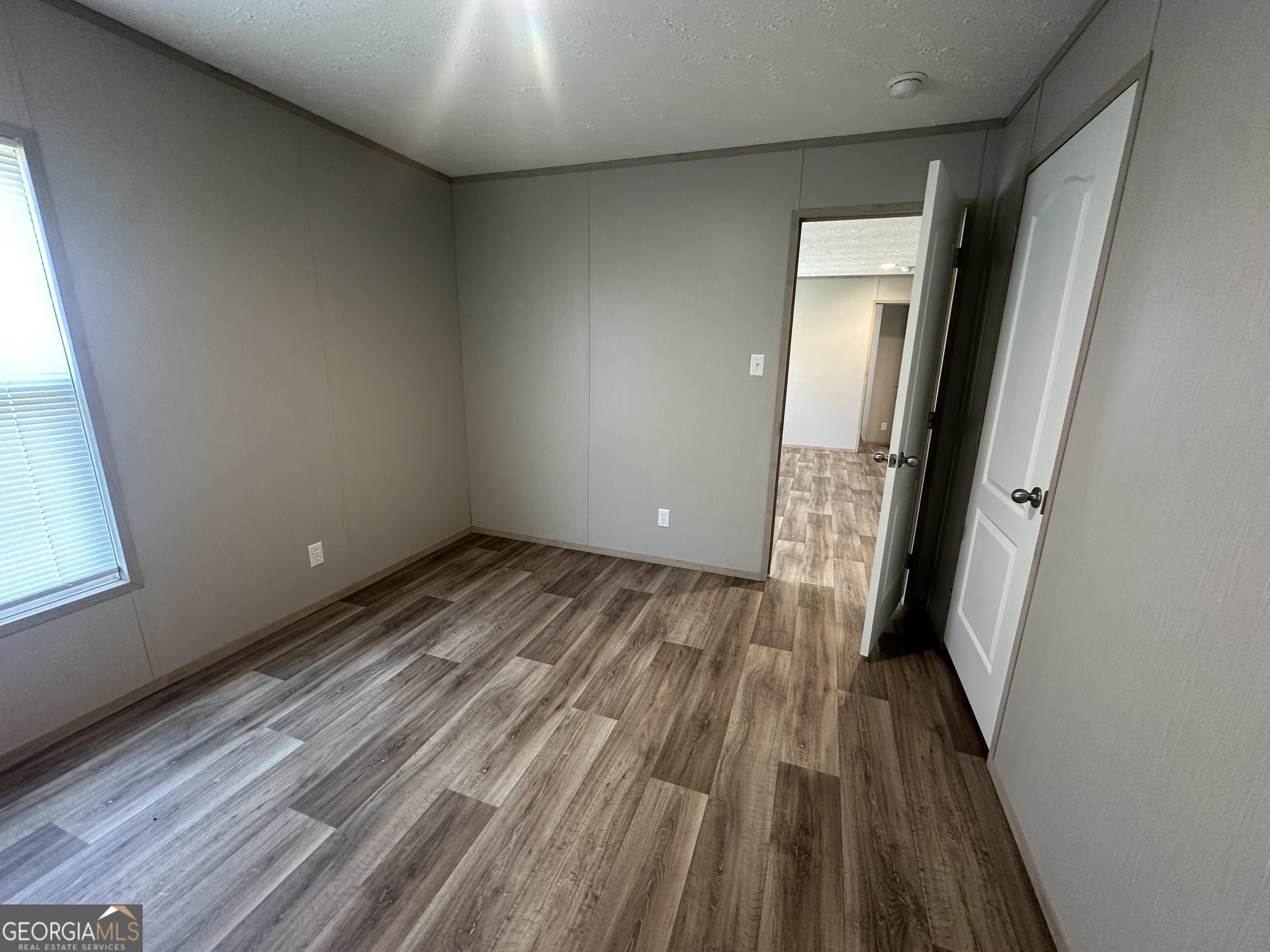 2470 Kitchen Road Dexter, GA 31019 - Photo 32 of 56 a view of a room with wooden floor and staircase