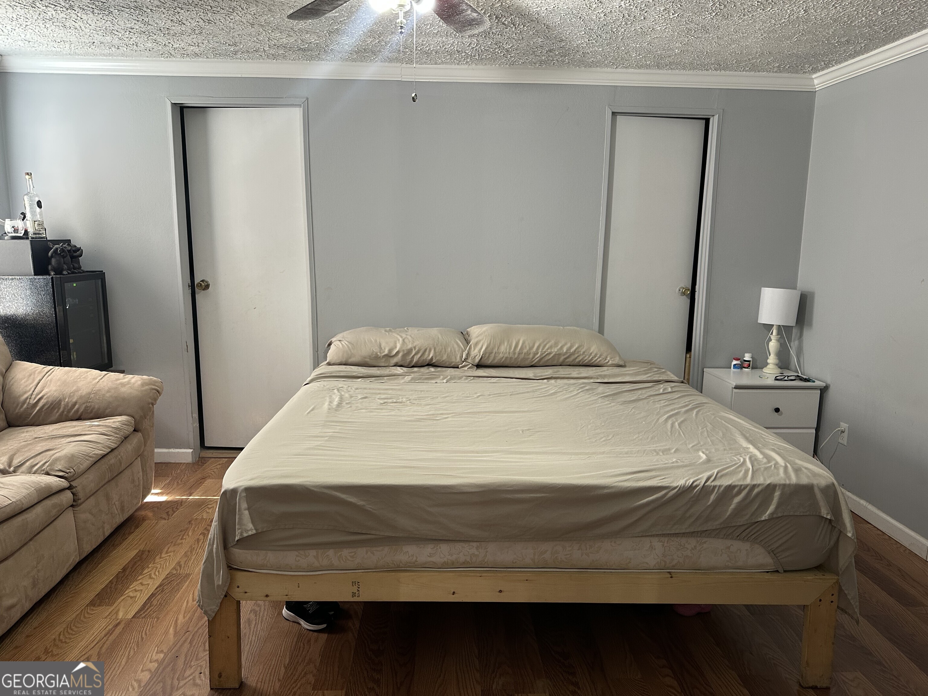 2470 Kitchen Road Dexter, GA 31019 - Photo 52 of 56 a bedroom with a bed and wooden floor