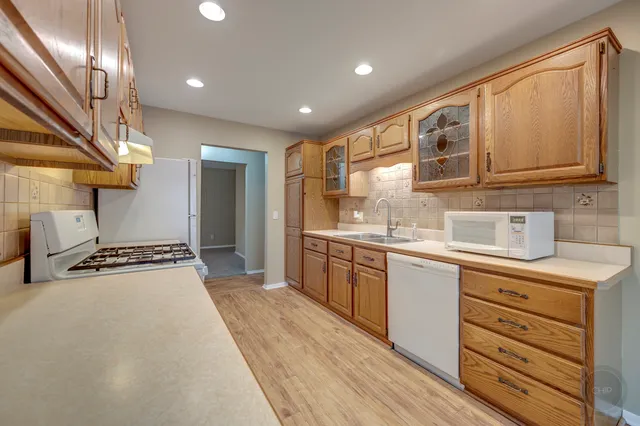 a kitchen with granite countertop a sink stainless steel appliances and cabinets